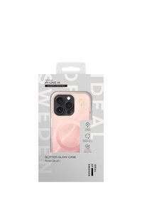 Etui na telefon z błyszczącym brokatem do iPhone 16 w kolorze różowego rumieńca. Posiada przezroczysty design z błyszczącym wykończeniem oraz wytrzymałość potwierdzoną testami upadku. Kompatybilne z MagSafe.