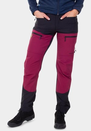 Outdoor pants featuring a maroon upper section and black lower section, made of durable fabric with two zippered pockets on the thighs.