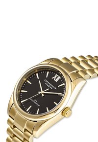 Goldene Armbanduhr mit schwarzem Ziffernblatt, goldenen Stundenmarkierungen und Zeigern; zeigt "Copenhagen Studios", wasserdicht bis 50 m, mit einem verlinkten Metallband.