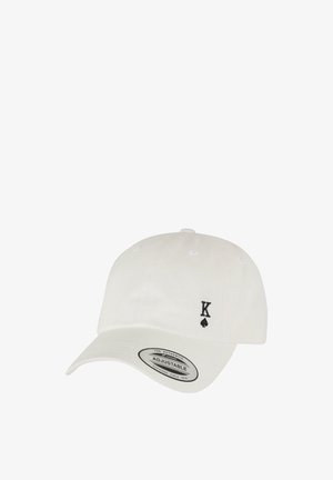 Casquette de baseball en coton blanc avec une sangle ajustable, arborant un logo noir "K" et un trèfle à l'avant. Visière plate avec des trous de ventilation.