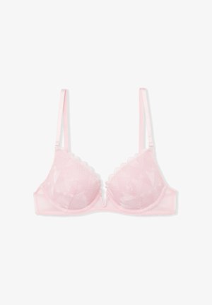 Light pink padded bra with heart-patterned overlay, scalloped edges, adjustable straps, and a central decorative v-shaped accent.