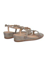 Sandali con zeppa in taupe chiaro con decorazioni floreali. Presentano una cinghia alla caviglia regolabile e materiale morbido e testurizzato. Tacco basso e solido.
