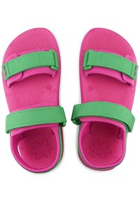 Pink sandals featuring a textured rubber sole, green adjustable straps, and a contoured footbed for comfort and fit.