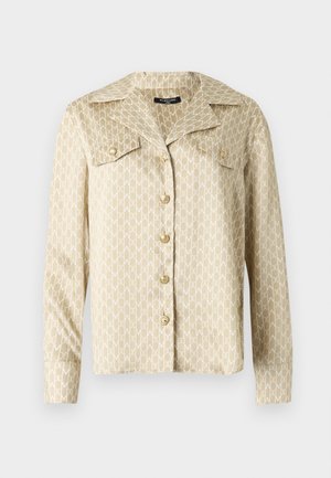 Bézs ingdzseki nagy gallérral, gombos záródással és egész felületén fehér logómintával. Hosszú ujjú, gombos mandzsettával, sima anyagtextúrával.