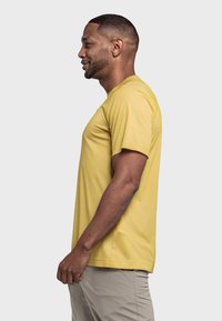 Gelbes Rundhals-T-Shirt, kurze Ärmel, aus weichem Stoff. Seitenansicht zeigt lockere Passform und glatte Textur. Leichte Freizeitkleidung.