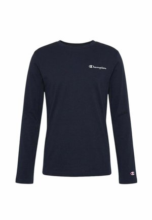 Camicia a maniche lunghe blu navy con logo Champion sul petto sinistro e logo più piccolo sul polsino della manica sinistra.
