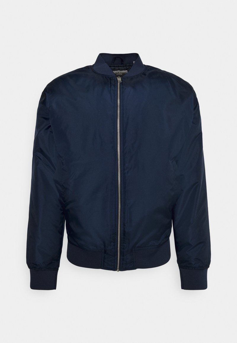 Veste bomber bleu marine avec fermeture éclair argentée à l'avant, col, poignets et ourlet côtelés, présentée sur un fond clair uni.