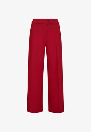 Czerwone spodnie o szerokich nogawkach z gładką fakturą. Posiadają jeden czarny guzik i szlufki na pasek. Prosty design, bez wzorów i widocznych kieszeni.