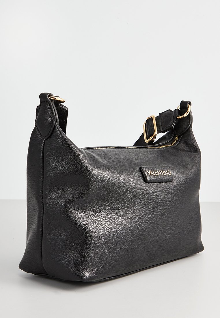 Bolso de hombro Valentino de cuero negro texturizado con cremallera dorada y correa ajustable con hebilla dorada, expuesto sobre una superficie blanca.