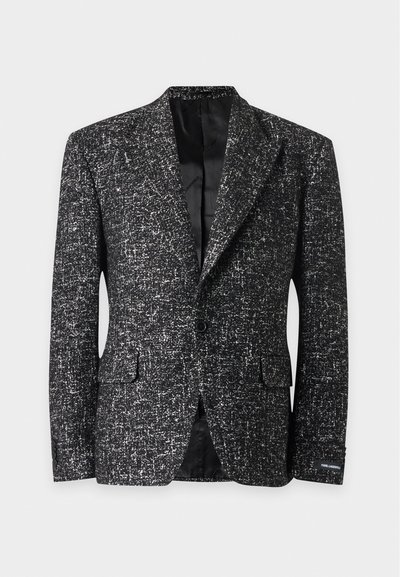 Veste noire et blanche texturée à un bouton, avec revers crantés, poches à rabat et doublure intérieure en satin noir.