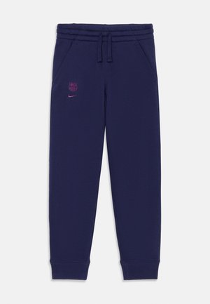 Navy blue sweatpants made of soft fabric, featuring an elastic waistband, side pockets, and a pink Nike logo along with a Barcelona crest.