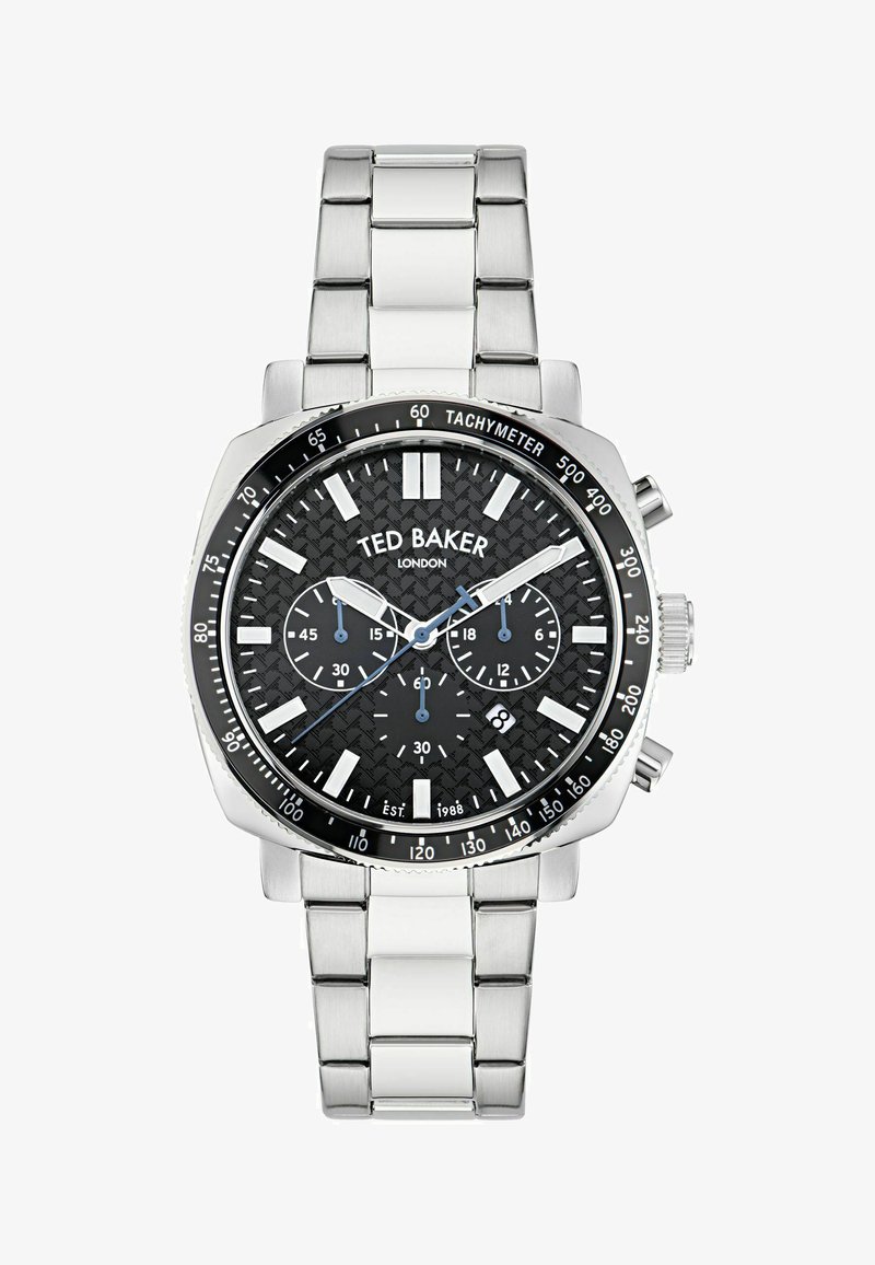 Hõbedane roostevabast terasest kell musta tekstuuriga valida, valged tunnimärgid ja kronograafi funktsioonid. Sisaldab takümeetrilist äärist.