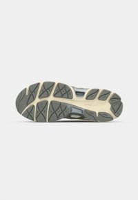 Running shoe with a textured gray rubber sole, featuring a beige midsole, reinforced overlays, and a minimalist design for support.