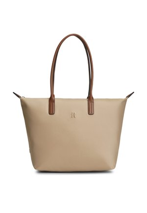 Beige mulepose med lange brune håndtag og et lille frontlogo, vist på hvid baggrund.