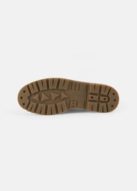 Brown rubber sole with a grooved pattern, featuring triangular treads and circular designs. Smooth texture with branding printed on.