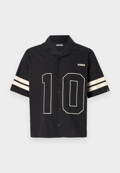 Black short-sleeve button-up shirt featuring a large cream number "10" design and stripes on the sleeves. Material appears smooth and lightweight.