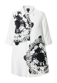 White button-up shirt featuring large black floral patterns and tribal motifs on one side, with a smooth, lightweight fabric and 3/4 sleeves.