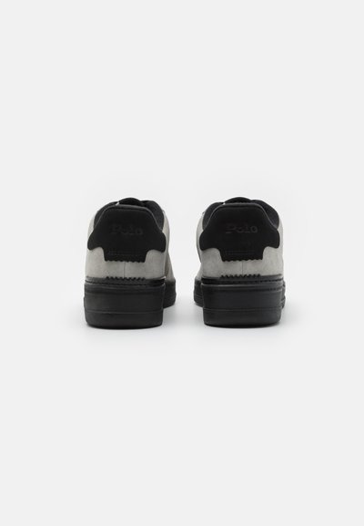 Black and grey suede sneakers featuring a textured surface, rounded shape, and a distinct heel design with "Polo" embossed.