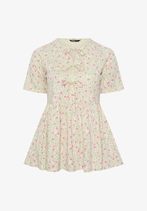 Kremowa bluzka z krótkim rękawem w różowy kwiatowy wzór, z trzema kokardami z przodu oraz rozkloszowanym dołem w stylu peplum.