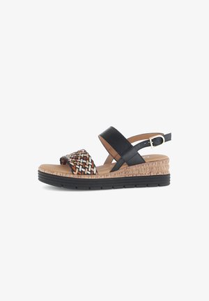 Black leather wedge sandals with woven multicolor strap. Cork platform and rubber sole provide grip. Adjustable ankle strap for fit.