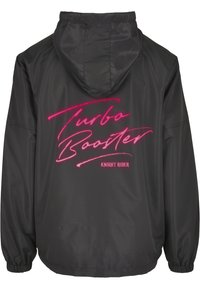 Musthave musta tuulejope, millel on kapuuts, elastsed mansetid ja suur roosa trükk "Turbo Booster" koos "Knight Rider" all.