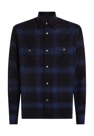 Dark blue plaid shirt made from textured fabric, featuring a pointed collar, snap buttons, and two chest pockets.
