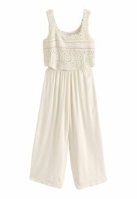 White jumpsuit featuring a crocheted top with a scalloped hem and wide, flowy legs. Made from lightweight fabric for comfort.