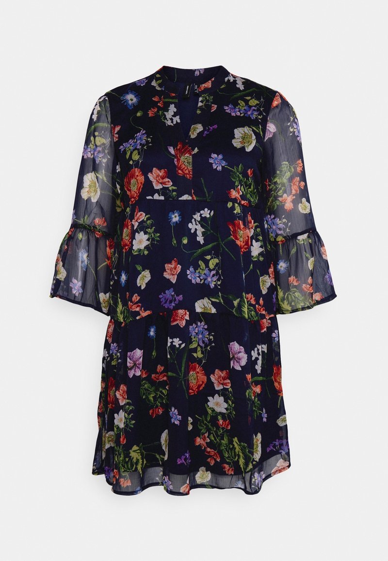 Robe fleurie avec un fond bleu marine foncé, manches longues transparentes, décolleté en forme de clé et poignets à volants. Présente un design en couches et fluide.