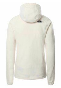 Giacca con cappuccio in pile crema con una texture morbida. Presenta un logo nero sulla parte alta della schiena. Maniche complete con cuciture raglan.