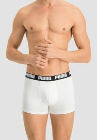 White cotton boxer briefs with a black elastic waistband featuring the "PUMA" logo in white. Smooth texture and fitted design.