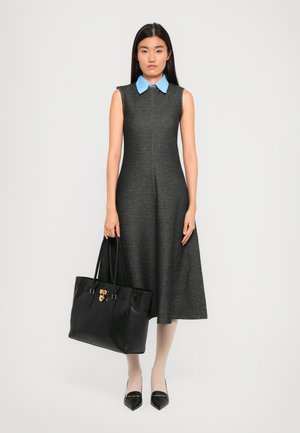Sleeveless gray dress with a light blue collar, A-line shape. Holds a black leather tote with gold hardware; wears nude tights and black flats.