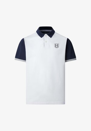 White polo shirt with navy collar and sleeves, light gray sleeve cuffs, and a small "H" logo patch on the left chest.