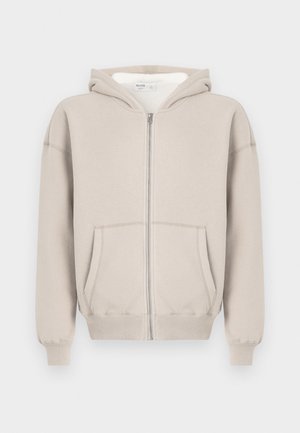 Súeter de capuz cinza claro com fecho éclair, bolso frontal, punhos e bainha canelados. Feito de um tecido macio com interior forrado e capuz com cordão.