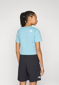 The North Face SIMPLE DOME CROPPED SLIM TEE - T-shirt imprimé - blue eclipse