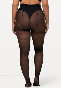 Collant in rete neri con vita alta, caratterizzati da un motivo testurizzato e un design della gamba senza cuciture, che offrono copertura e supporto completo.