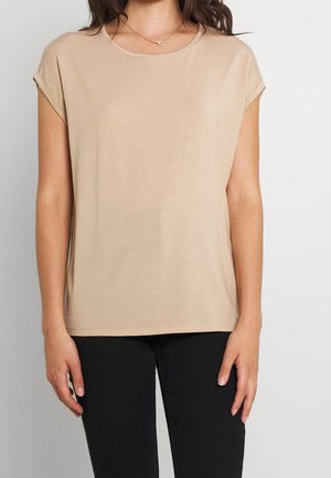 Beige short-sleeve top made of soft fabric, featuring a round neckline and rolled cuffs, paired with black fitted pants.