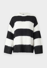 Black and white striped sweater with a loose fit, round neckline, and long sleeves; made from soft, fuzzy material.