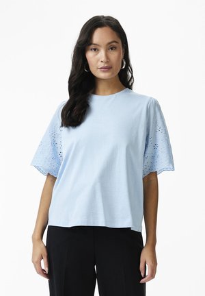 Light blue short-sleeved top made of soft fabric. Features embroidered eyelet details on sleeves and a round neckline, relaxed fit.