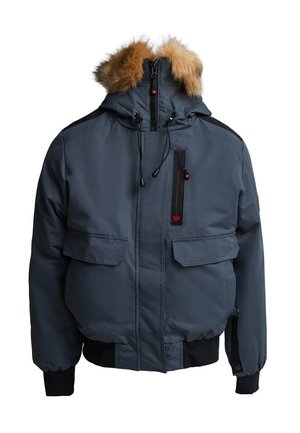 Navy blauwe gewatteerde jas met een bont gevoerde capuchon, dubbele voorzakken, een verticale ritszak en elastische manchetten en taille.