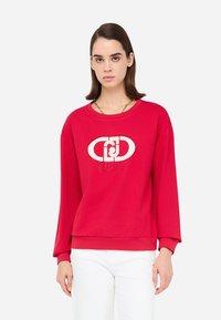 FELPA Rossa in cotone con collo a giro e maniche lunghe. Presenta un design con logo bianco al centro e polsini e orlo a costine.