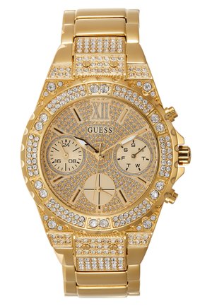 Goldfarbenes Guess Armbanduhr mit Kristallakzenten, römischer Zahl XII, drei Unterzifferblätter für 24 Stunden, Tag und Sekunden, Metallgliederarmband.