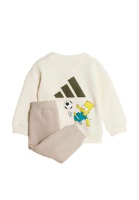 Cream sweatshirt with green Adidas logo and Bart Simpson graphic, paired with beige pants. Soft fabric, ribbed cuffs.