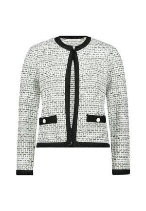 Tweed-Jacke in Schwarz und Weiß mit rundem Ausschnitt, offenem Vorderteil, zwei Fronttaschen mit Knöpfen und Fransenverzierungen entlang der Kanten.