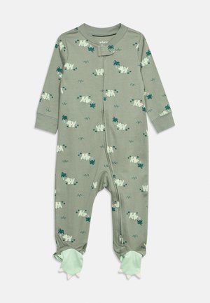 Green baby romper with all-over white rhino and palm tree print, front zipper, and dragon claw foot covers.