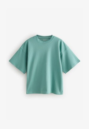 Majica mint zelene boje, prevelikog kroja, napravljena od mekanog pamuka, s okruglim izrezom i kratkim rukavima. Glatka tekstura bez uzoraka ili naglašavanja.