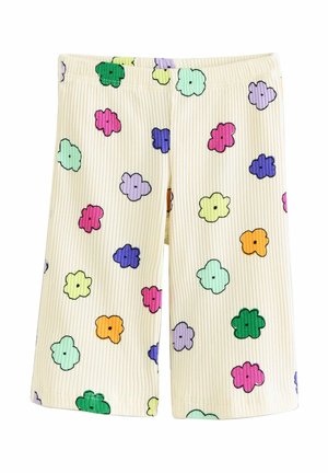 Kremfarvede ribstrikkede shorts med elastisk talje, der har flerfarvede tegneserieblomster i grøn, pink, lilla, gul, orange og blå.