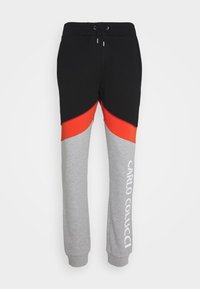 Colorblock-Jogginghose mit schwarzem, rotem und grauem Stoff. Elastischer Bund mit Kordelzug und weiß gedrucktem Logo am grauen Bein.