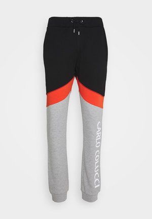 Sweatpants met kleurblokjes in zwart, rood en grijs. Elastische tailleband met trekkoord en een wit logo op het grijze been gedrukt.