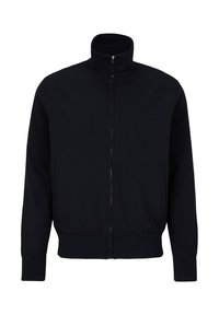 Dunkelblaue Zip-Jacke mit hohem Kragen, gerippter Textur, seitlichen Taschen und taillierten Bündchen. Leicht und aus dehnbarem Stoff gefertigt.