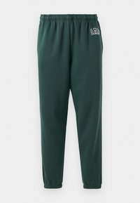 Green sweatpants made of soft fabric, featuring an elastic waistband, tapered legs, and a small GAP logo on the left hip.